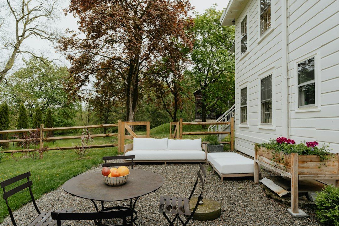 A patio with a table and chairs and a couch